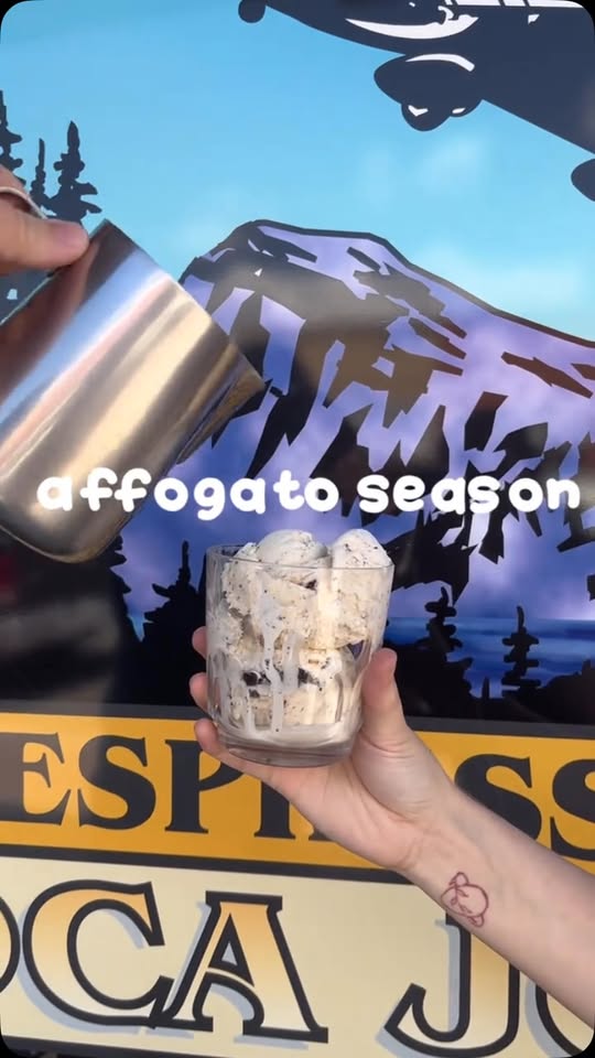 A barista pours an affogato in front of Moca Joe's airplane-over-the-mountains mural