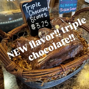 Basket of fresh-baked triple chocolate scones with a handwritten $3.25 price sign